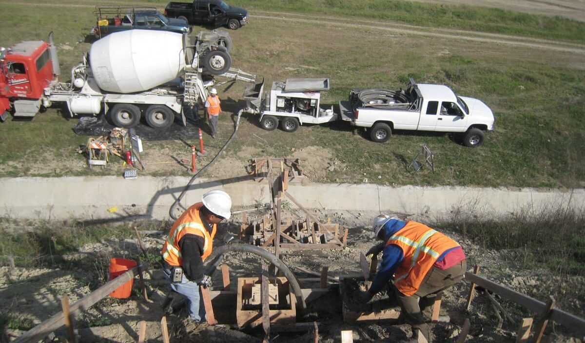 ENVTL_San-Onofre-LF-StairsIMG_0099-min Looking down slope with people working on equipment and concrete mixer truck and pickup
