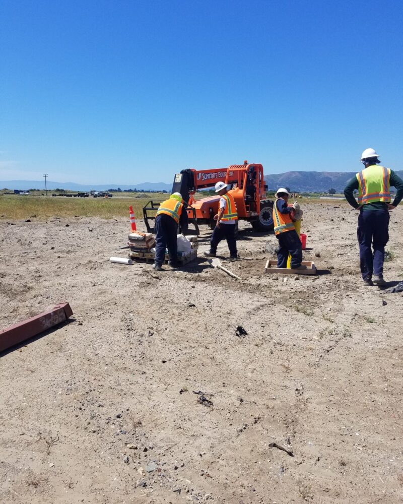 20190611_WellRehab_HP four people working in a sandy area
