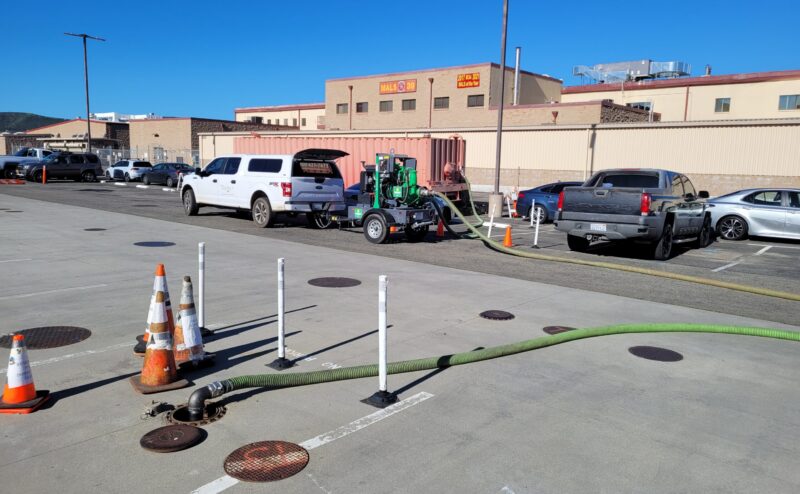 20230125_095647 white truck pulling equipment and tube running into the concrete opening