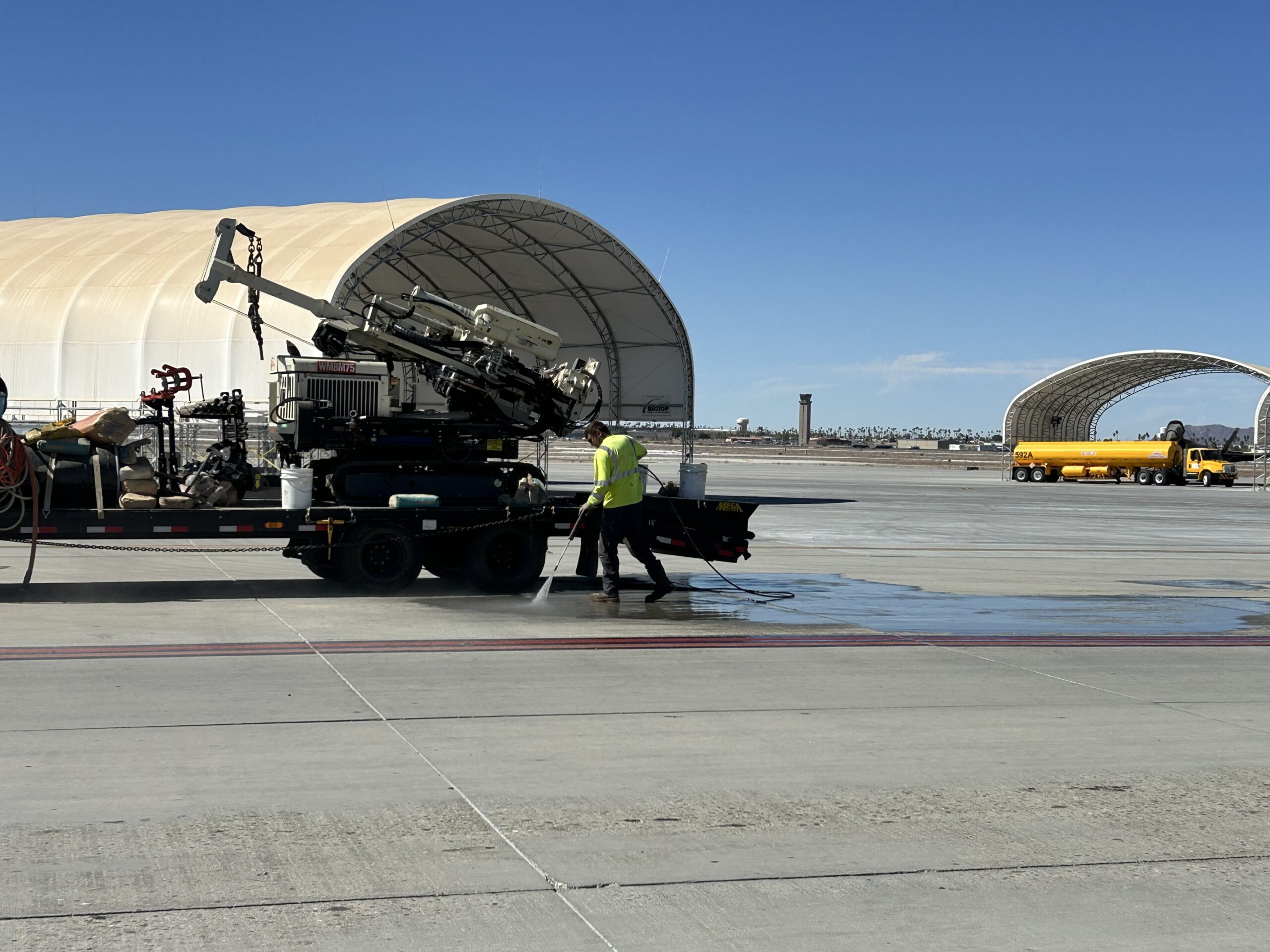 person using pressure washer on airfield