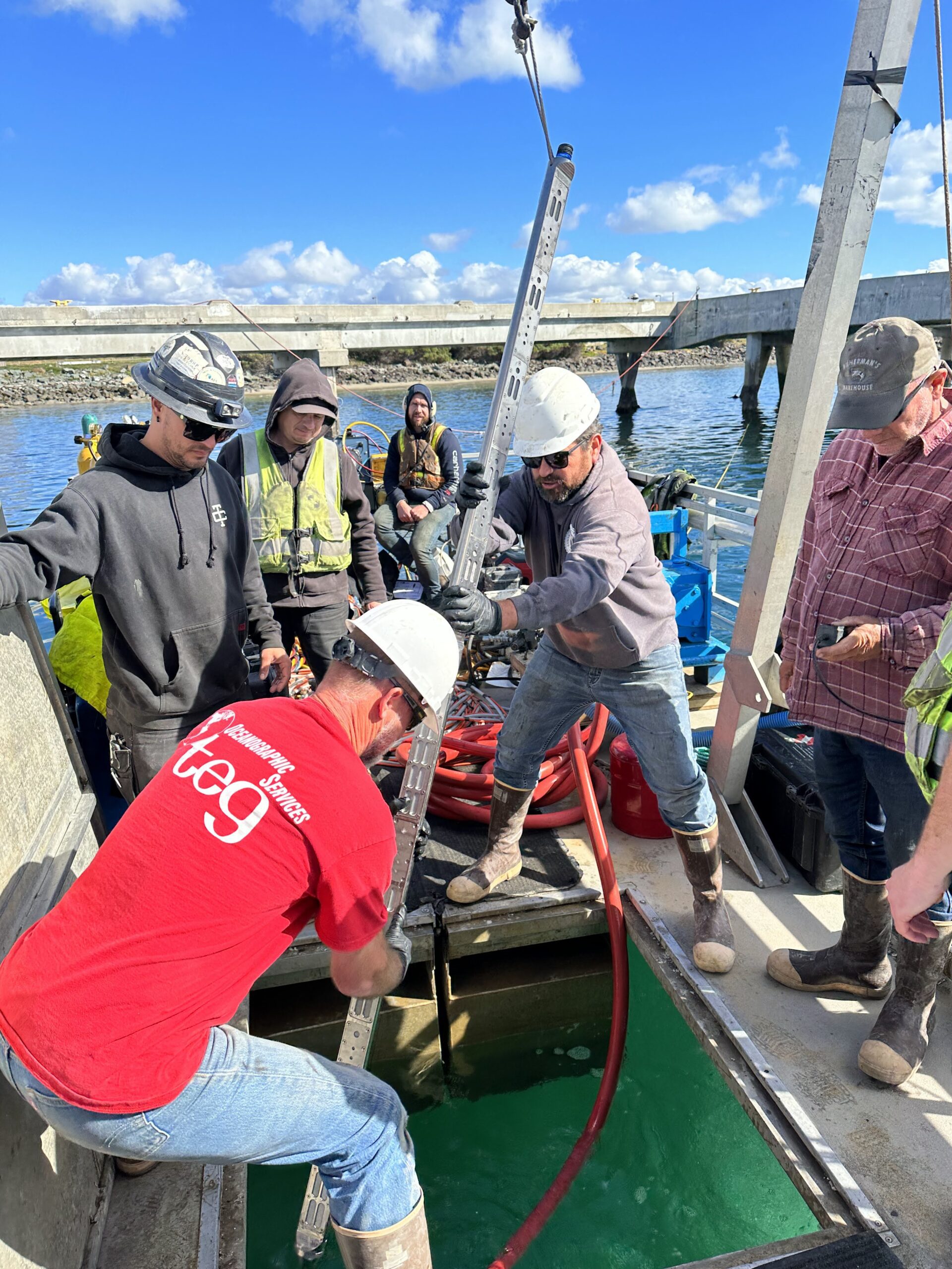 HRPPDeploy_IR9 group of people on a boat using equipment in the water