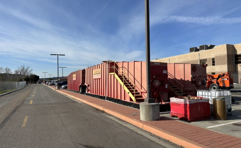 IMG_3815 large red equipment in parking lot by road