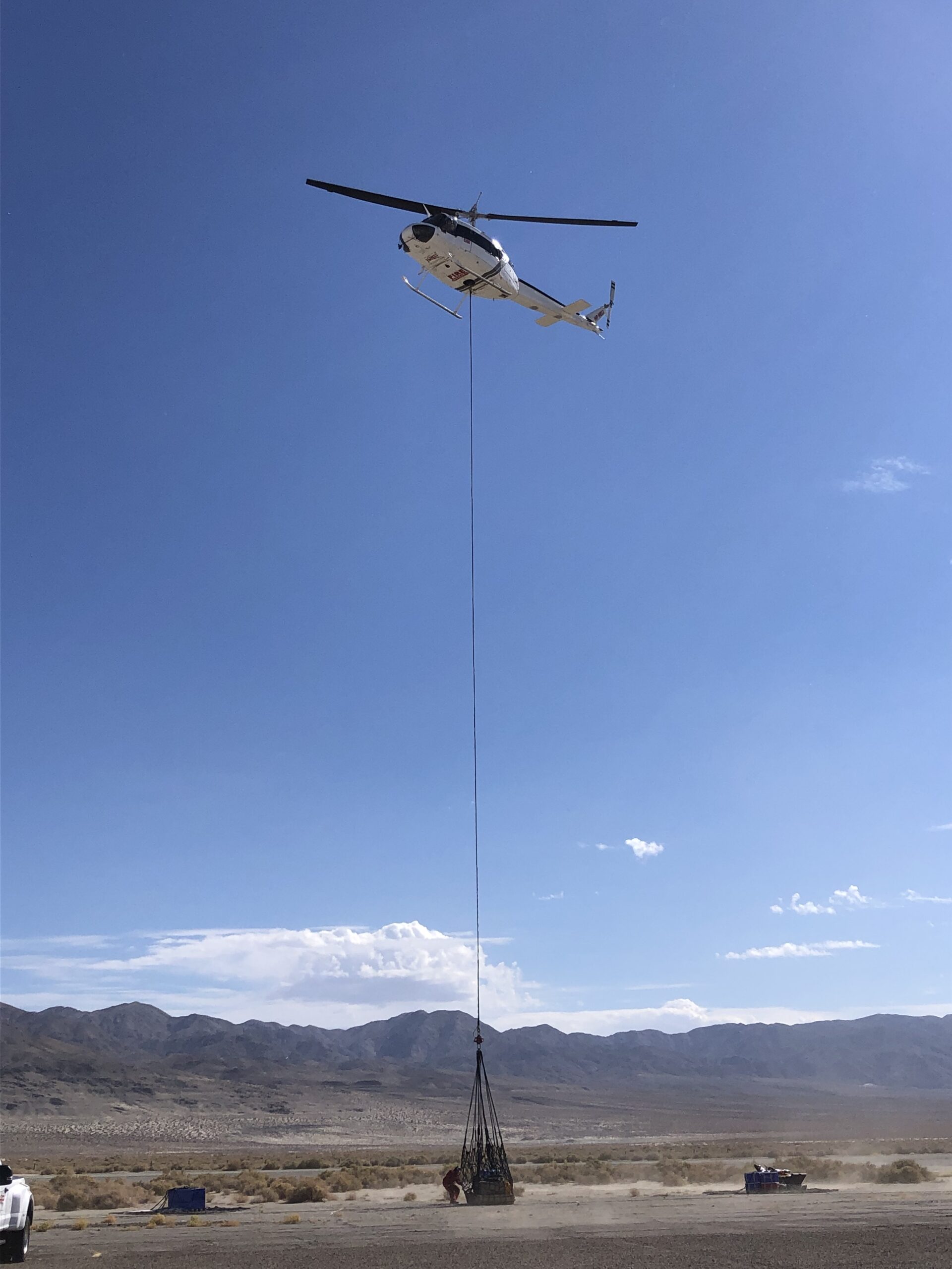 IMG_5352 helicopter setting down load in front of mountains