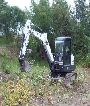 KS2 white excavator in grassy area