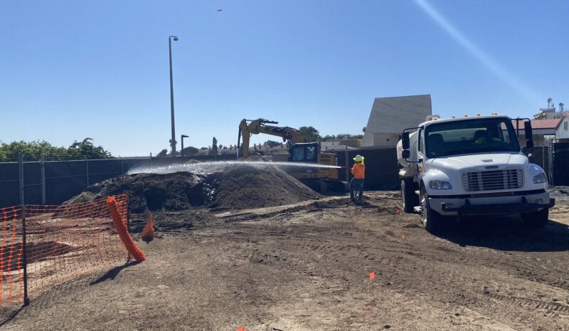 MRP 14 Stockpile1 water truck and person spraying large dirt pile