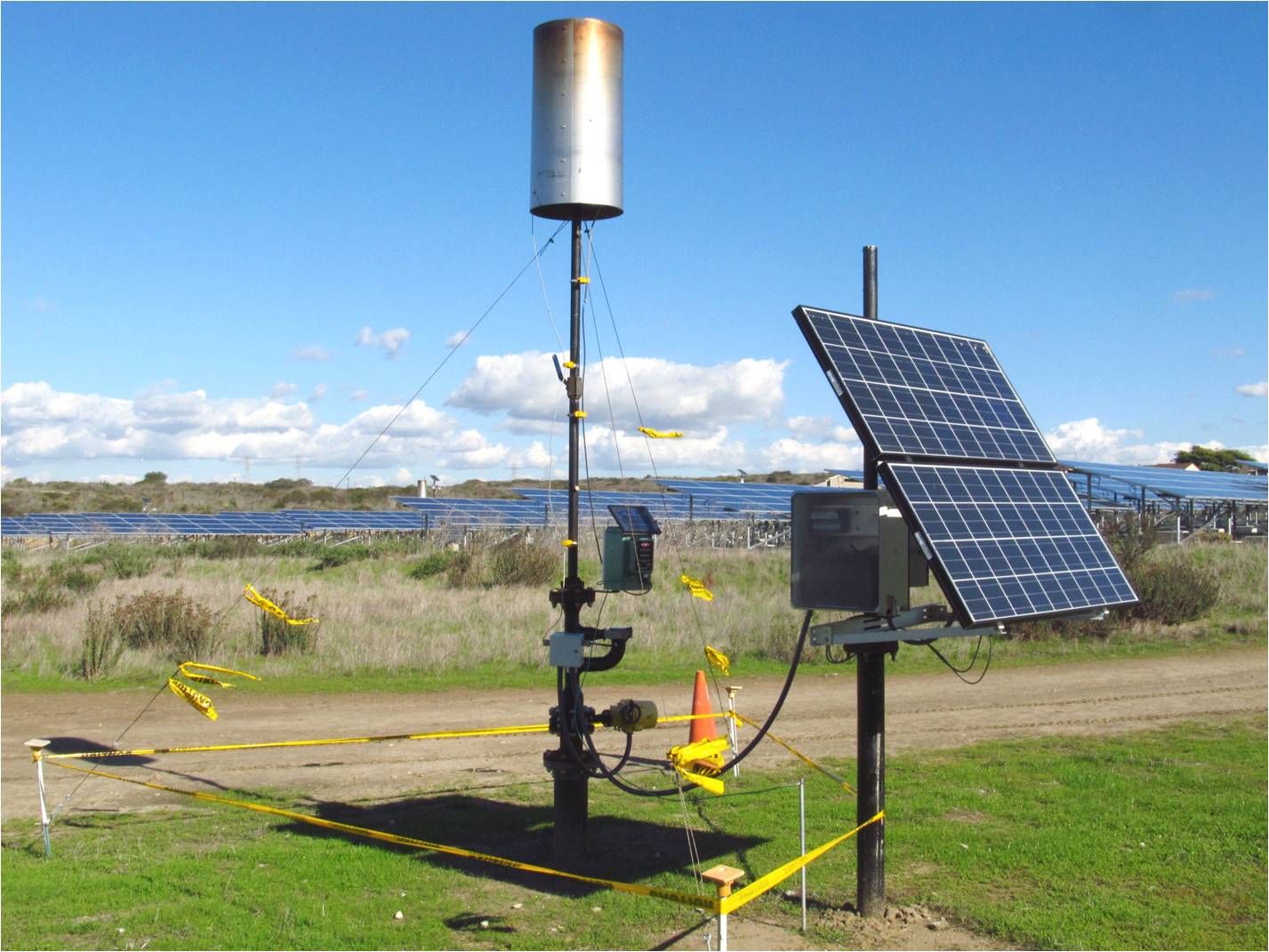 Picture63 small solar panel and tall equipment with large solar field behind
