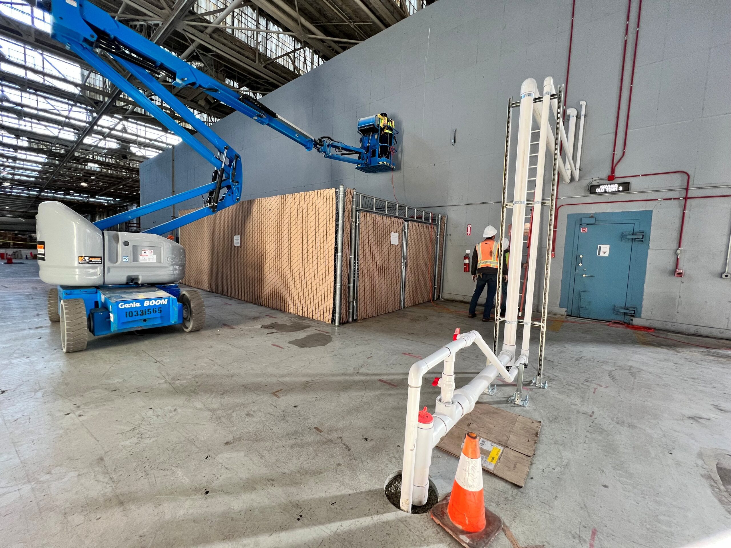 navwar sve 2 large boom lift in building with people working
