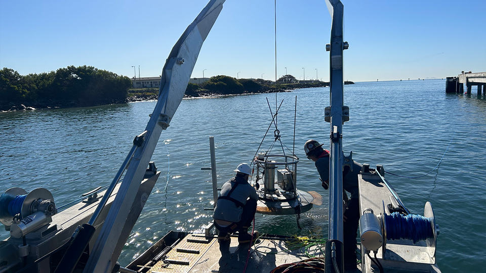 people working on the water with equipment